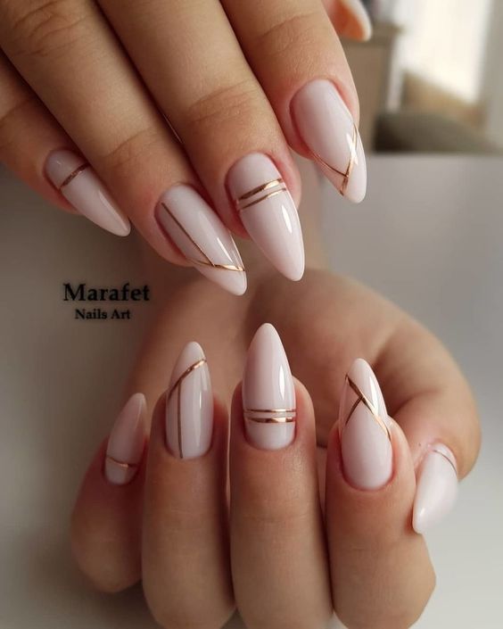 White Nails with Gold Lines on Almond Nails