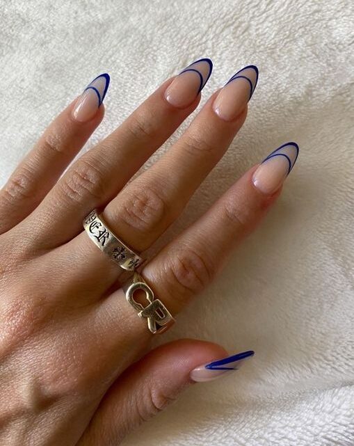 Puntas francesas de doble línea en tono azul en uñas acrílicas largas y redondas