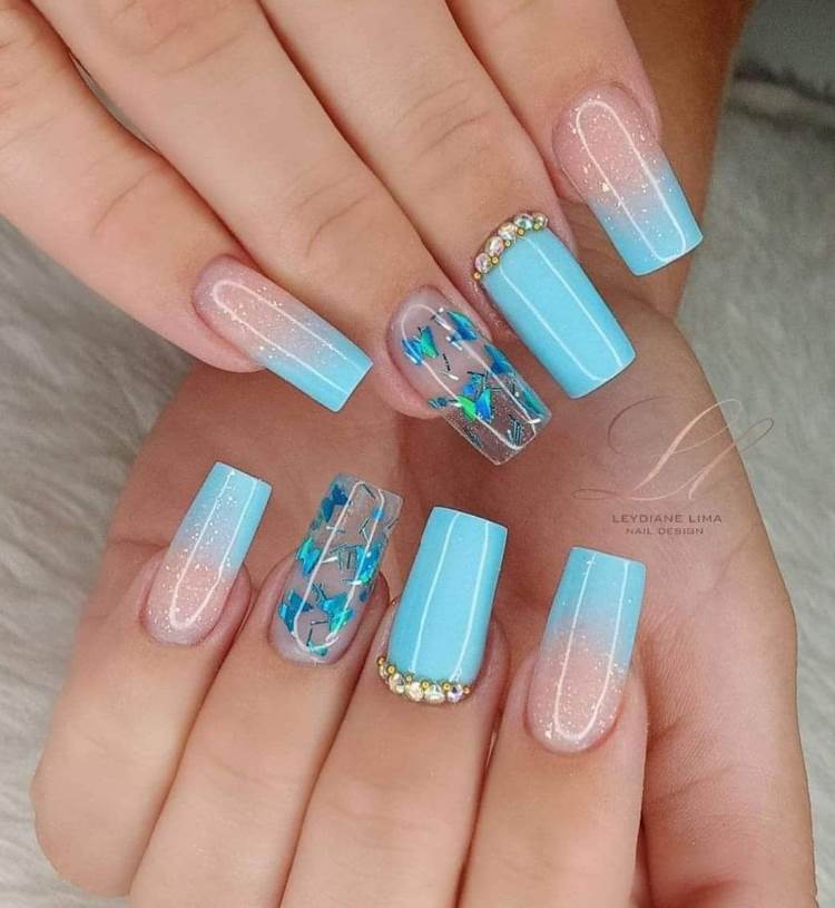 89 Decorated Nails pink square tip at the base encapsulated with blue butterflies light blue golden rhinestones at the tip